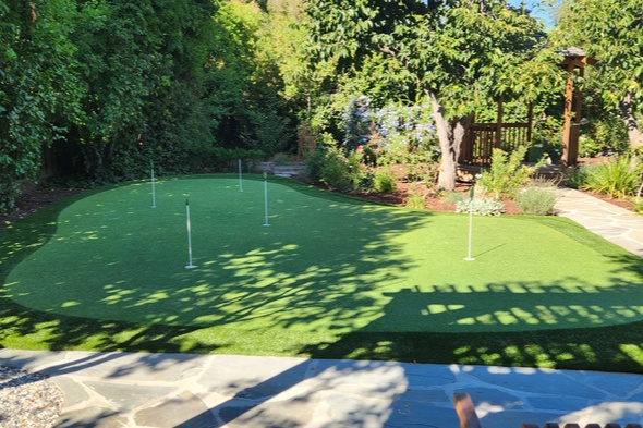 San Francisco backyard putting green with flags and trees